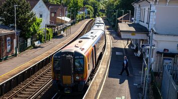 Train at a small UK station platform on a sunny day