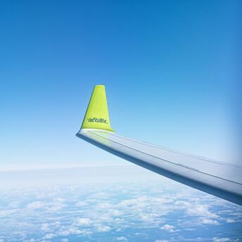 airBaltic wing seen above clouds during a flight
