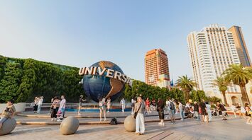 Visitors near the Universal globe at a resort entrance