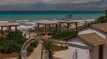 Beachfront area with cabanas on Corfu’s northern coast