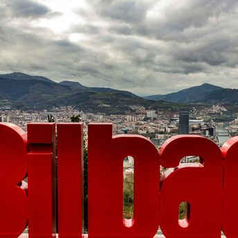 Bilbao city view with mountains and red sign