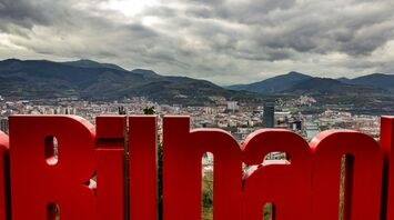 Bilbao city view with mountains and red sign