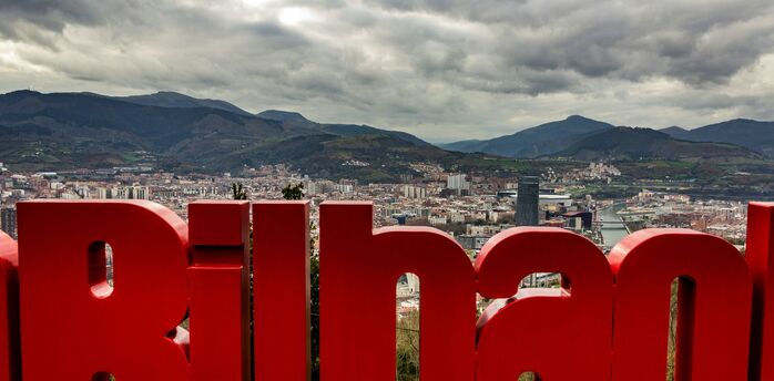 Bilbao city view with mountains and red sign