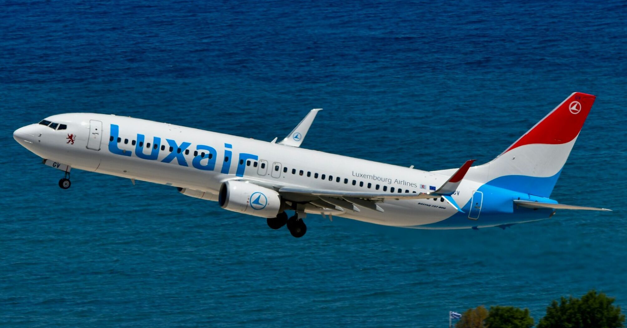 Luxair aircraft taking off over the coast