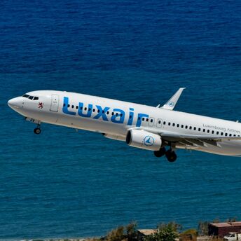 Luxair aircraft taking off over the coast