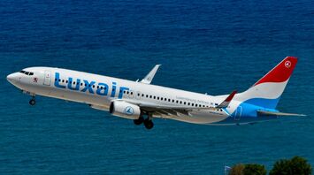 Luxair aircraft taking off over the coast