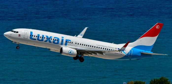 Luxair aircraft taking off over the coast