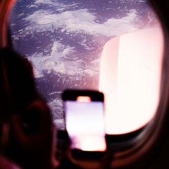 Passenger using a smartphone during a flight