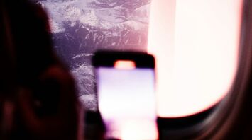 Passenger using a smartphone during a flight