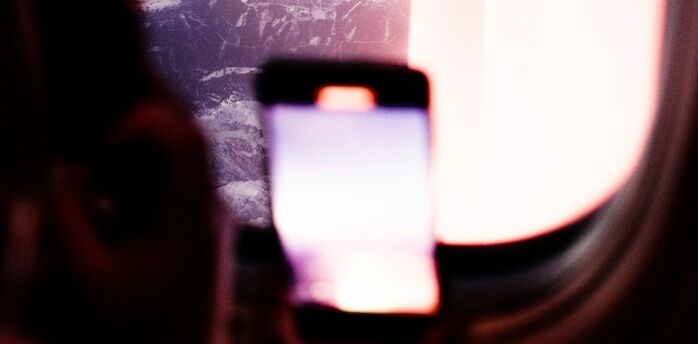 Passenger using a smartphone during a flight