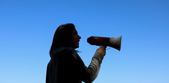 Woman speaking through a megaphone