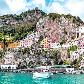Colourful Amalfi Coast buildings beneath steep cliffs