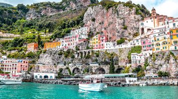 Colourful Amalfi Coast buildings beneath steep cliffs