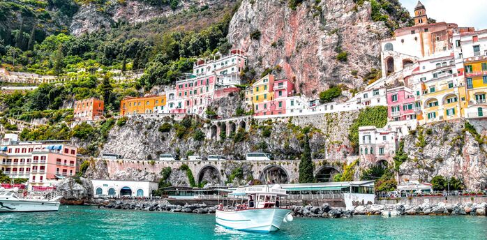 Colourful Amalfi Coast buildings beneath steep cliffs
