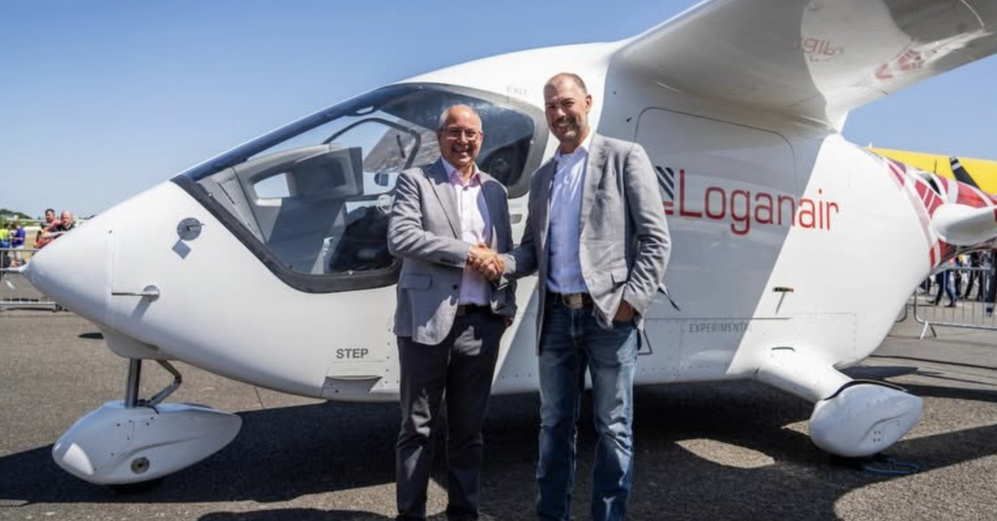 Representatives beside a Loganair-branded ALIA CX300