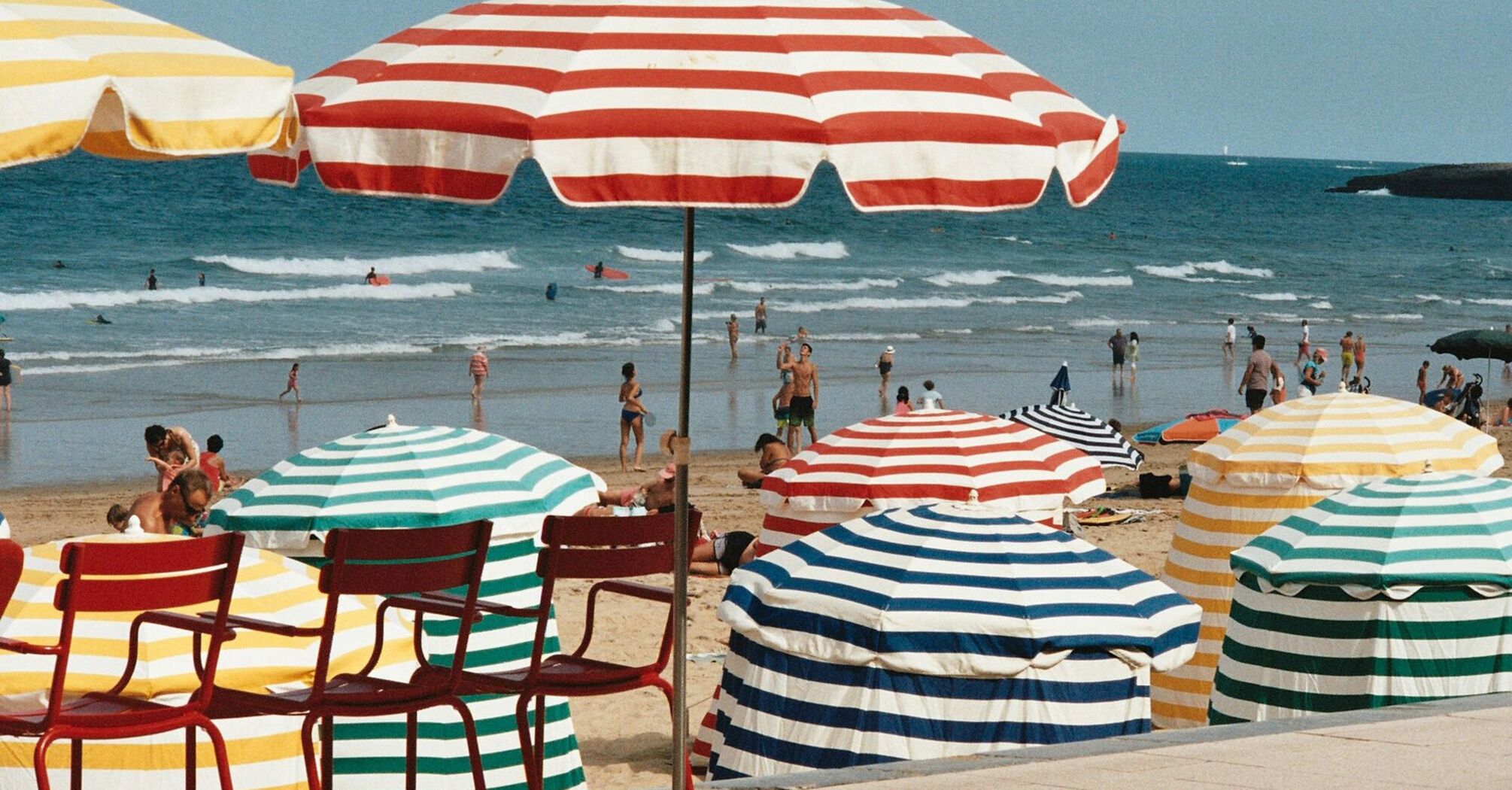 Colourful parasols on a busy French beach