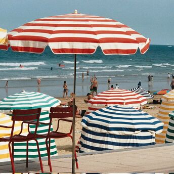 Colourful parasols on a busy French beach