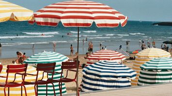 Colourful parasols on a busy French beach