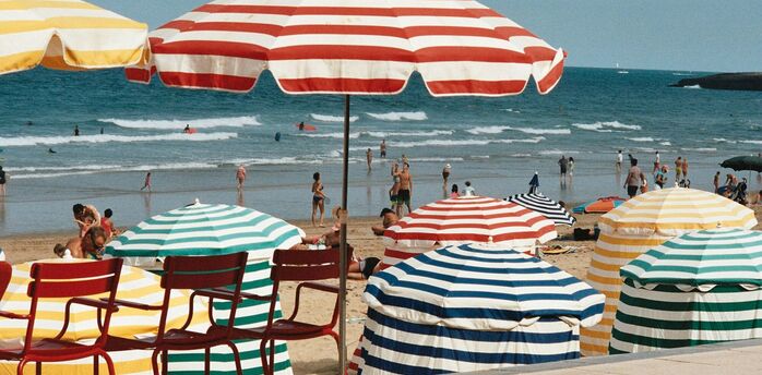 Colourful parasols on a busy French beach