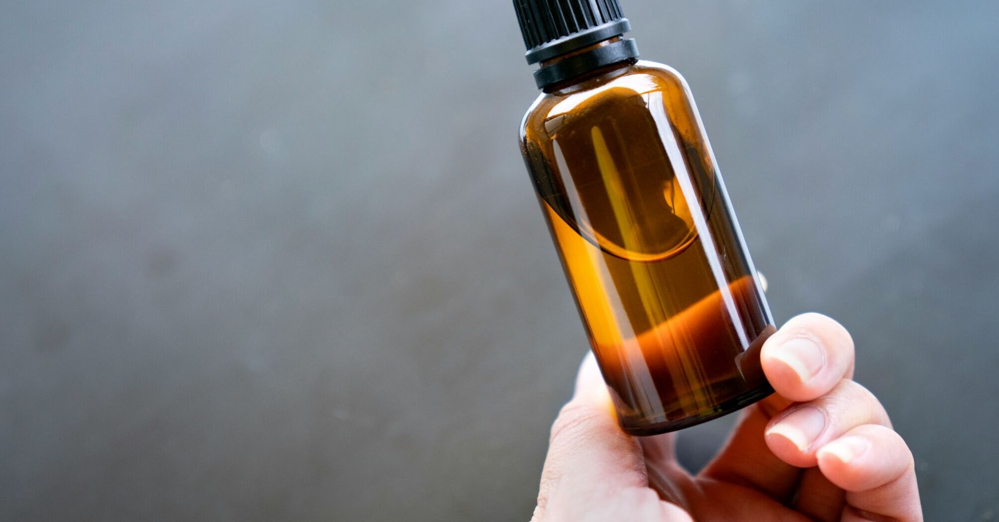 Hand holding a bottle of liquid