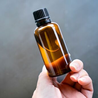 Hand holding a bottle of liquid