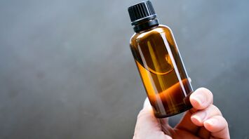 Hand holding a bottle of liquid