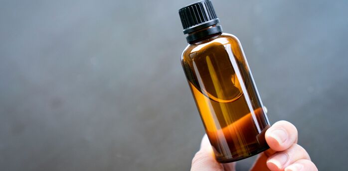 Hand holding a bottle of liquid