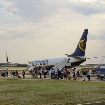 Passengers board a Ryanair aircraft at the airport