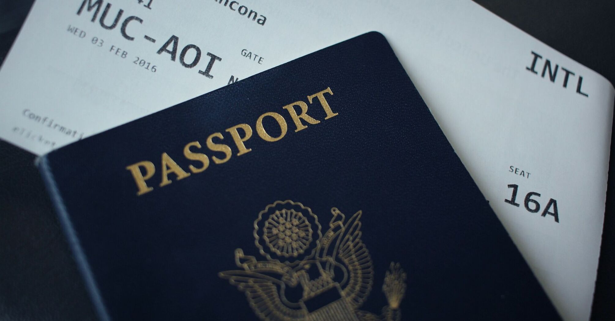 Passport resting on an international boarding pass