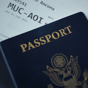 Passport resting on an international boarding pass