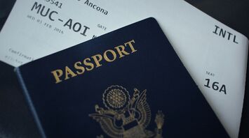 Passport resting on an international boarding pass
