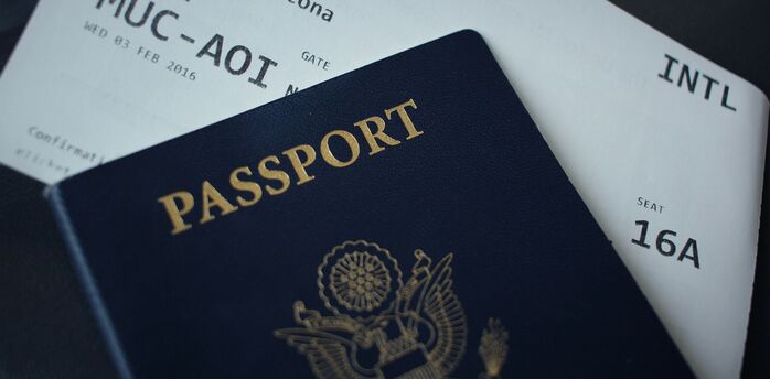Passport resting on an international boarding pass
