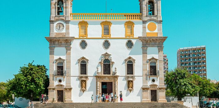 Historic church in Faro under a clear blue sky