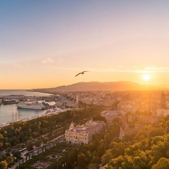 Sunset over Málaga harbour and city centre