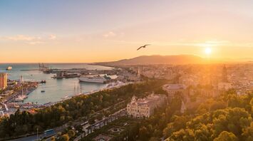 Sunset over Málaga harbour and city centre