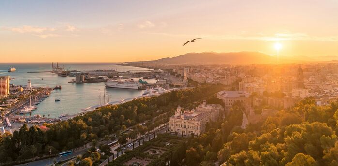 Sunset over Málaga harbour and city centre