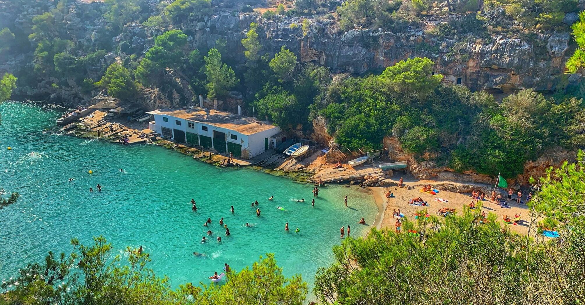 Turquoise cove on Mallorca with swimmers