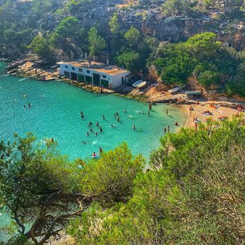 Turquoise cove on Mallorca with swimmers