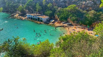 Turquoise cove on Mallorca with swimmers
