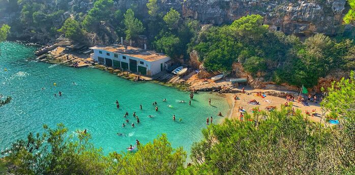 Turquoise cove on Mallorca with swimmers