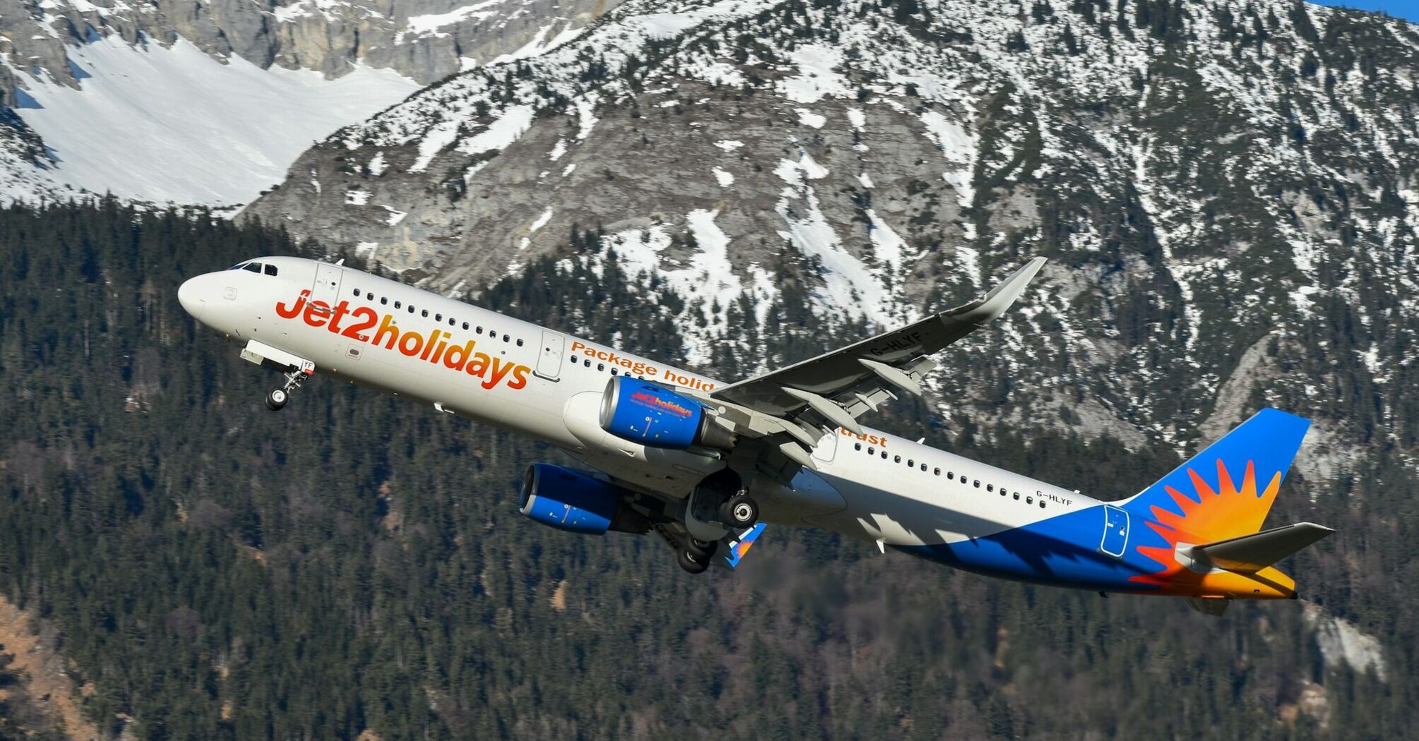 Jet2 aircraft flying over snow-covered Alps