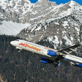 Jet2 aircraft flying over snow-covered Alps