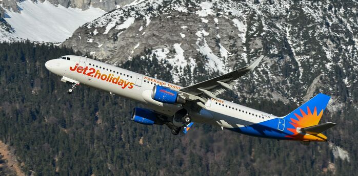 Jet2 aircraft flying over snow-covered Alps