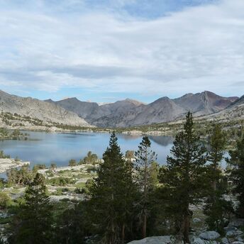 Mountain lake surrounded by rocky peaks and pine trees
