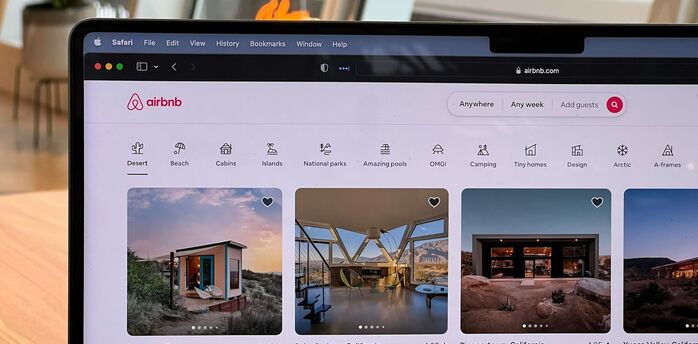 Airbnb accommodation listings on a laptop