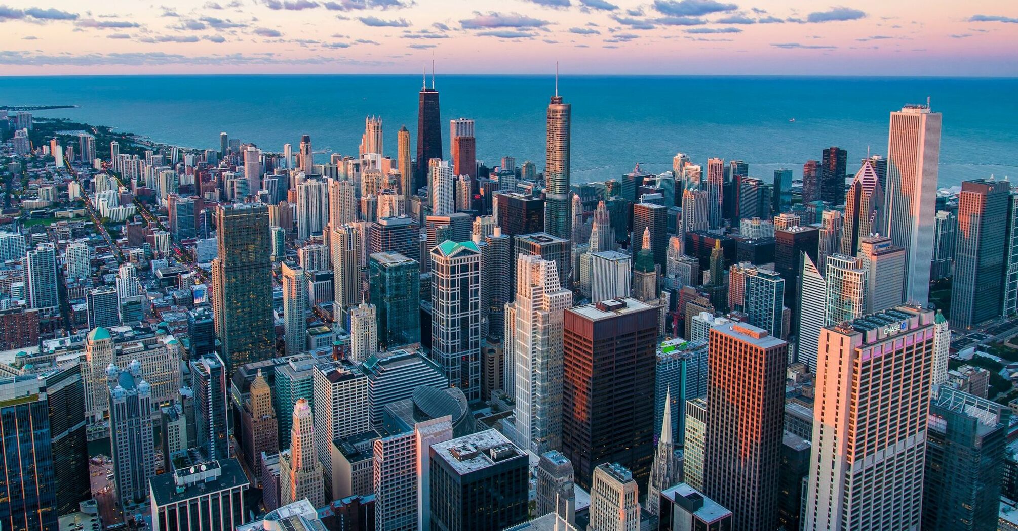 Chicago skyline beside Lake Michigan at sunset