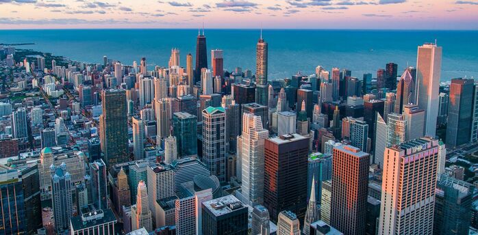 Chicago skyline beside Lake Michigan at sunset