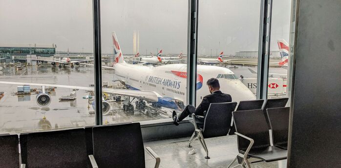 Passenger waiting beside British Airways aircraft