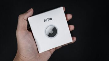 Apple AirTag box held in hand