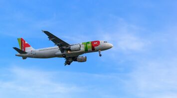 TAP Air Portugal aircraft landing in blue sky
